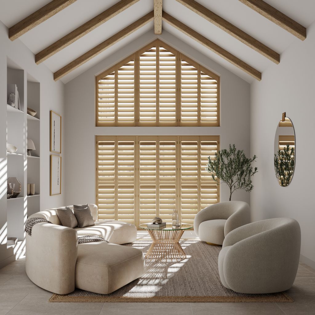 Vaulted gable window with natural wood shutters in a light-filled living room