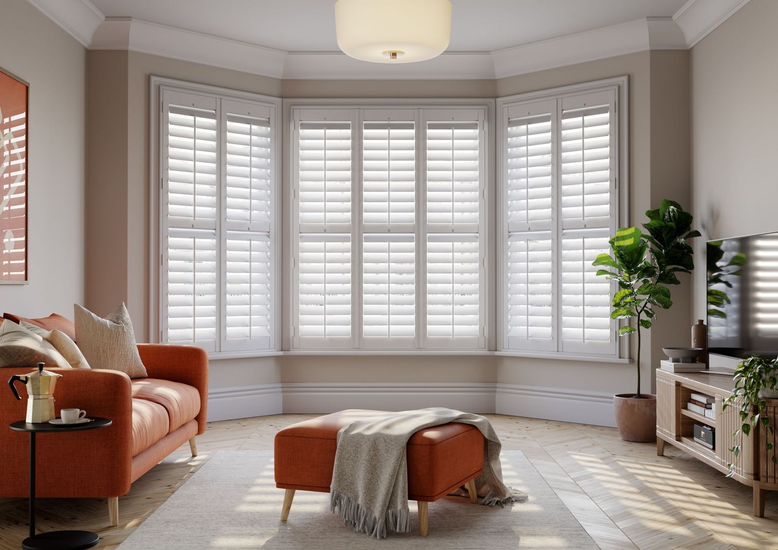 Living room bay window fitted with white full-height plantation shutters in a Newcastle home