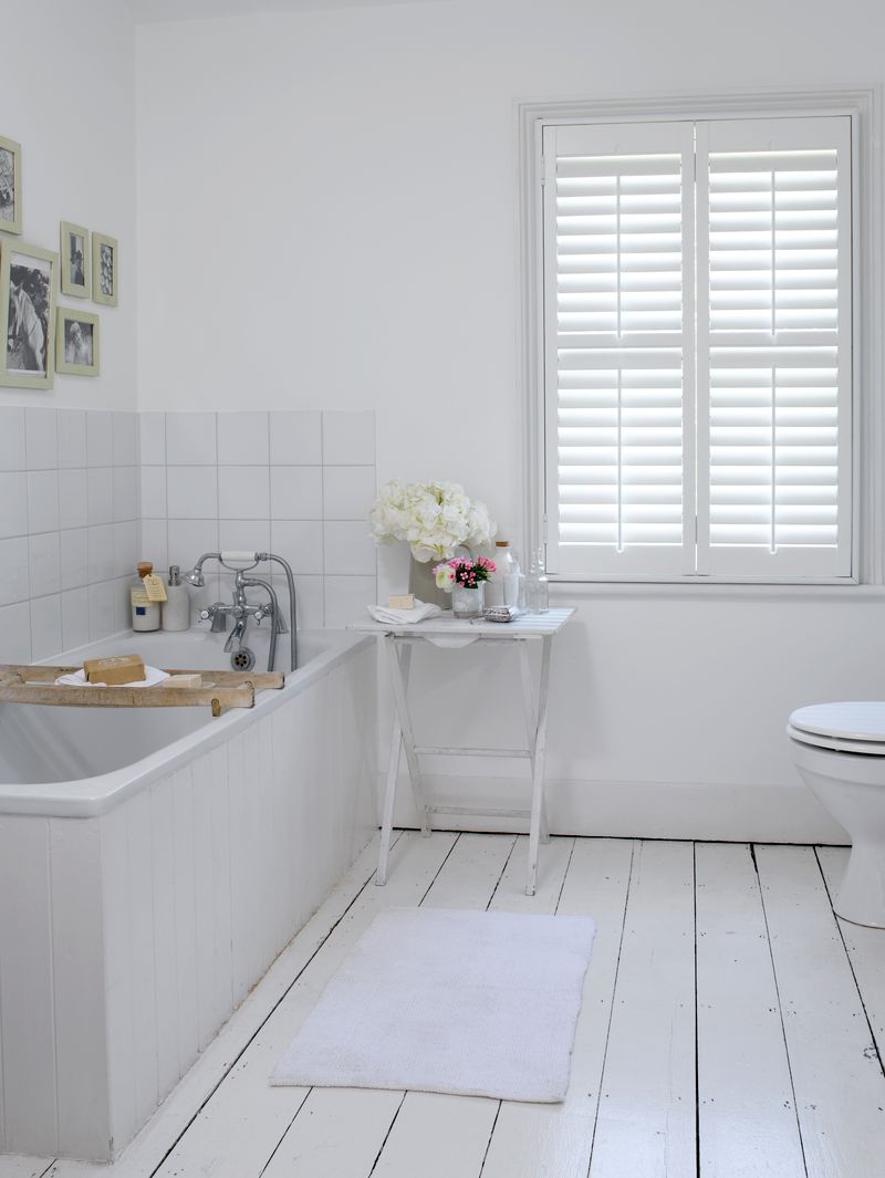 Bright bathroom with white waterproof plantation shutters
