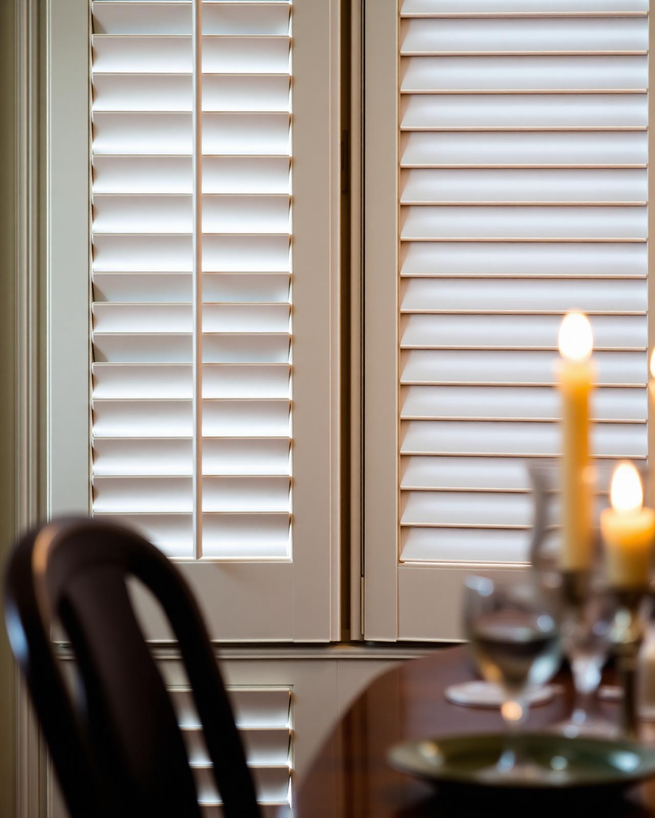 Close-up of louvres with candlelight reflection